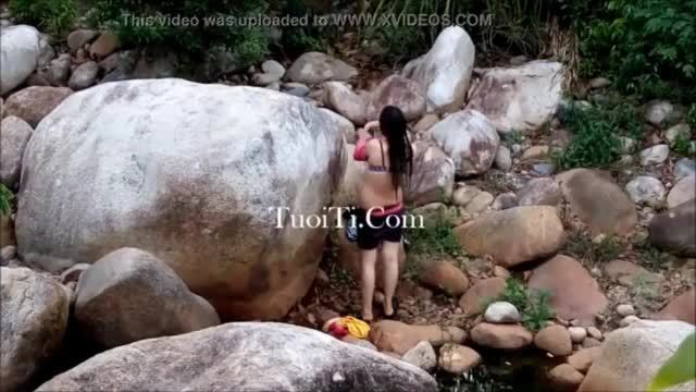 A girl change clothes inside the waterfall