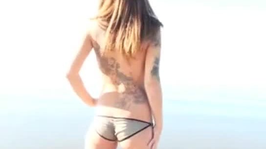 Punk girl nude at the beach