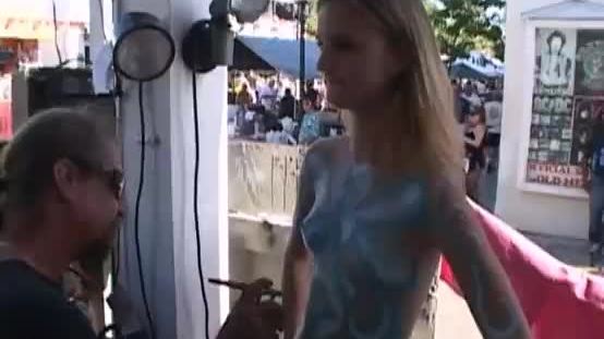 Teen girl getting body painted in public